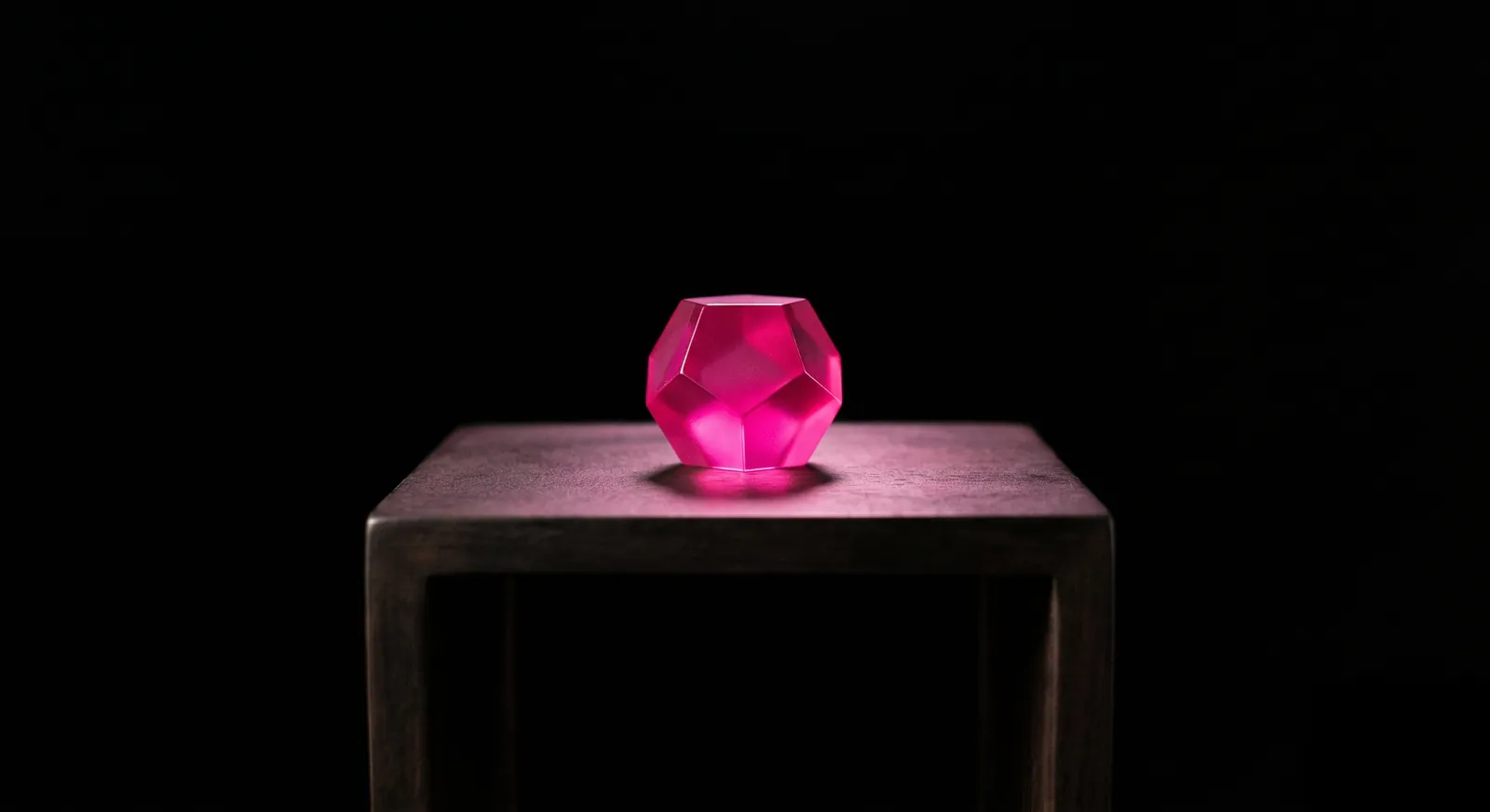 A luminous geometric polyhedron resting on a dark pedestal in a vast void, symbolizing something valuable offered freely as proof of engineering capability