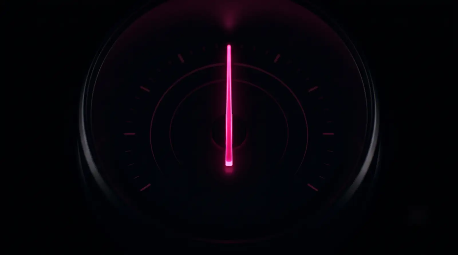 A hot-pink gauge needle holding steady at the center of a dark dial, illustrating automation maintenance and monitoring after launch