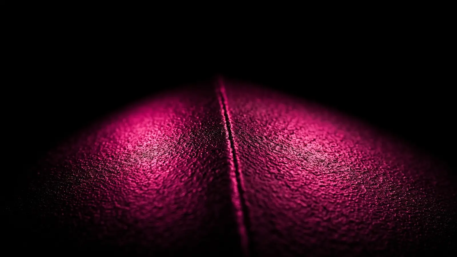 Two magenta-lit regions meeting along a defined edge on black, the division of work in co-managed IT