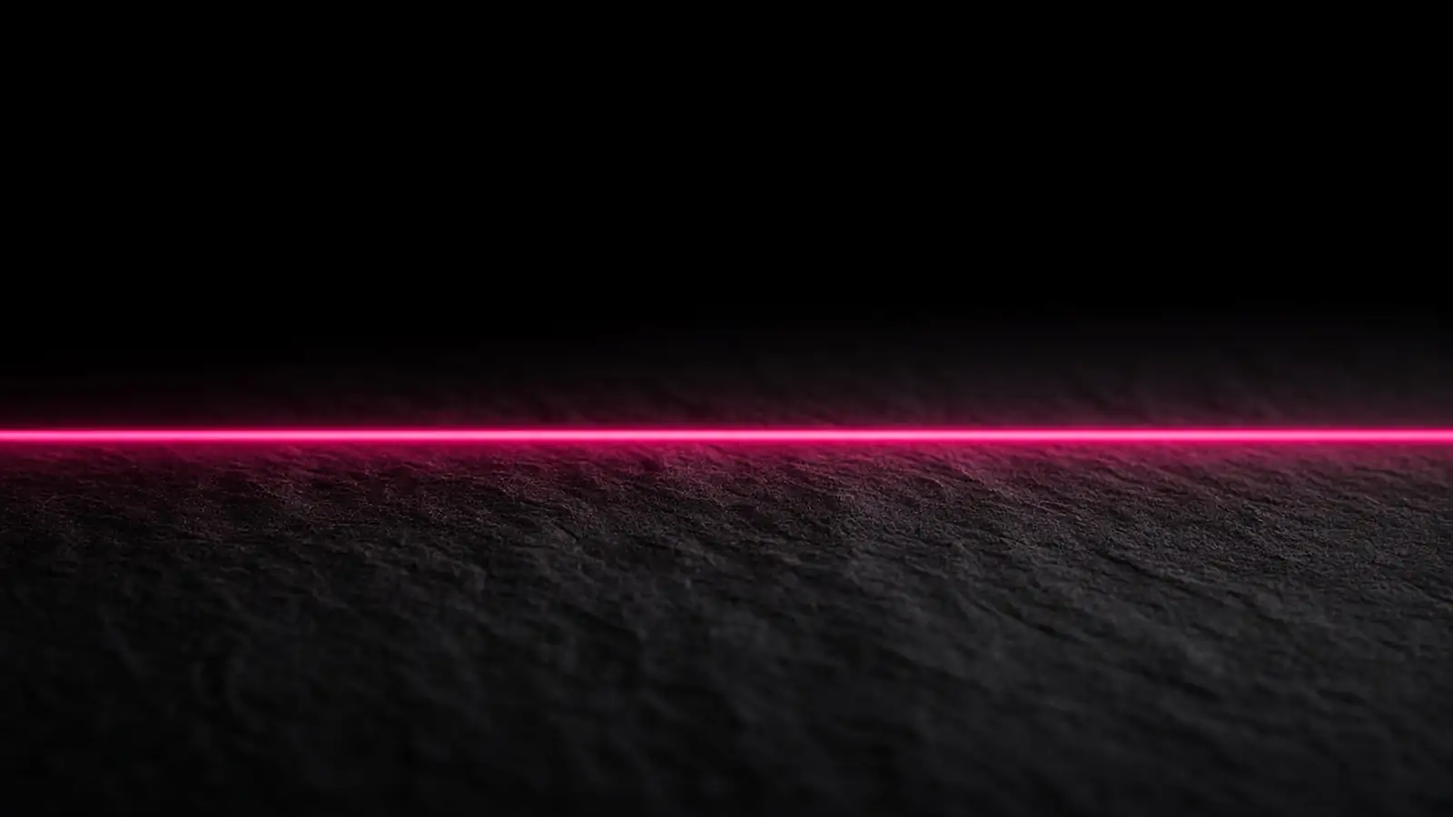A magenta line dividing a dark page into lit and unlit halves, cyber insurance exclusions defining the covered edge