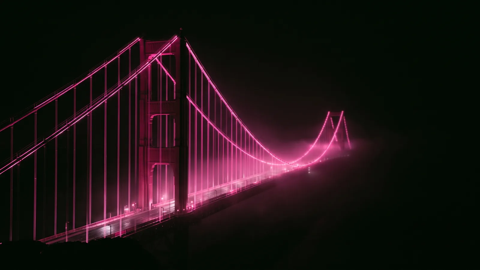 A long suspension bridge disappearing into fog at night with its cables traced in hot pink light, data transfers under GDPR for Massachusetts companies
