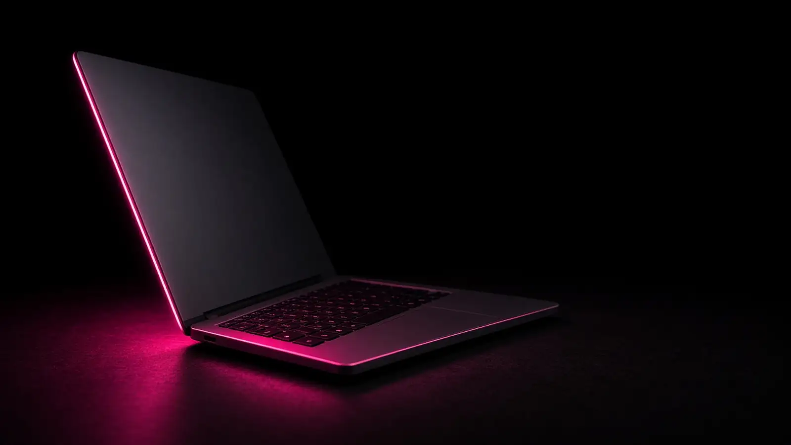 A laptop on a dark desk lit by a hot pink edge light, Massachusetts sales tax on SaaS subscriptions