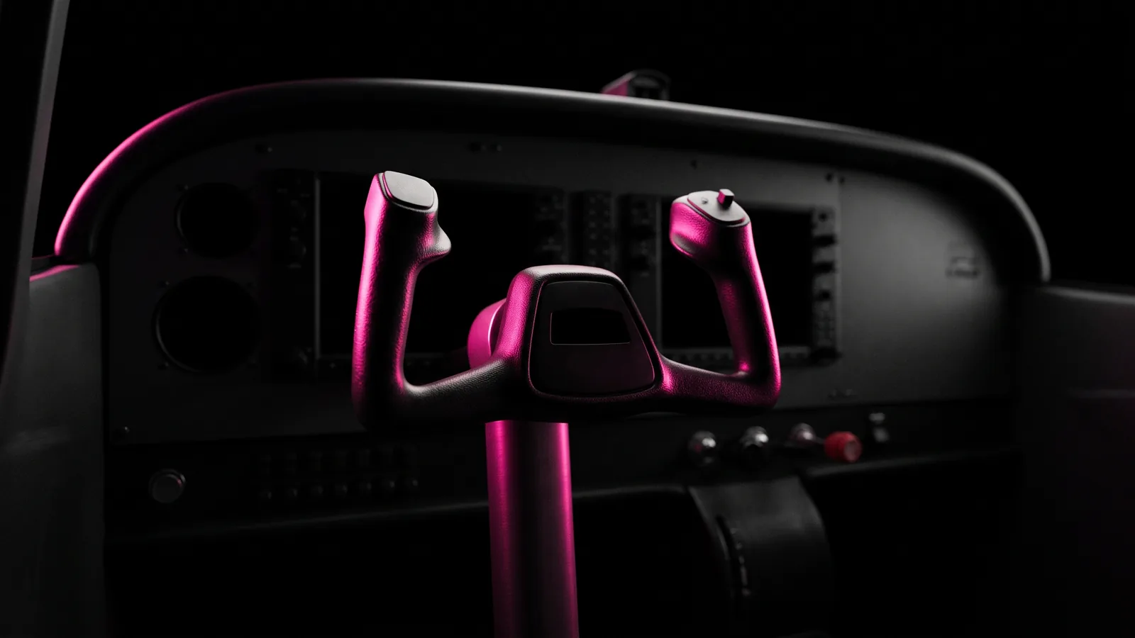 A flight simulator control yoke in a dark training cockpit, its grips and column edged in hot pink light against black