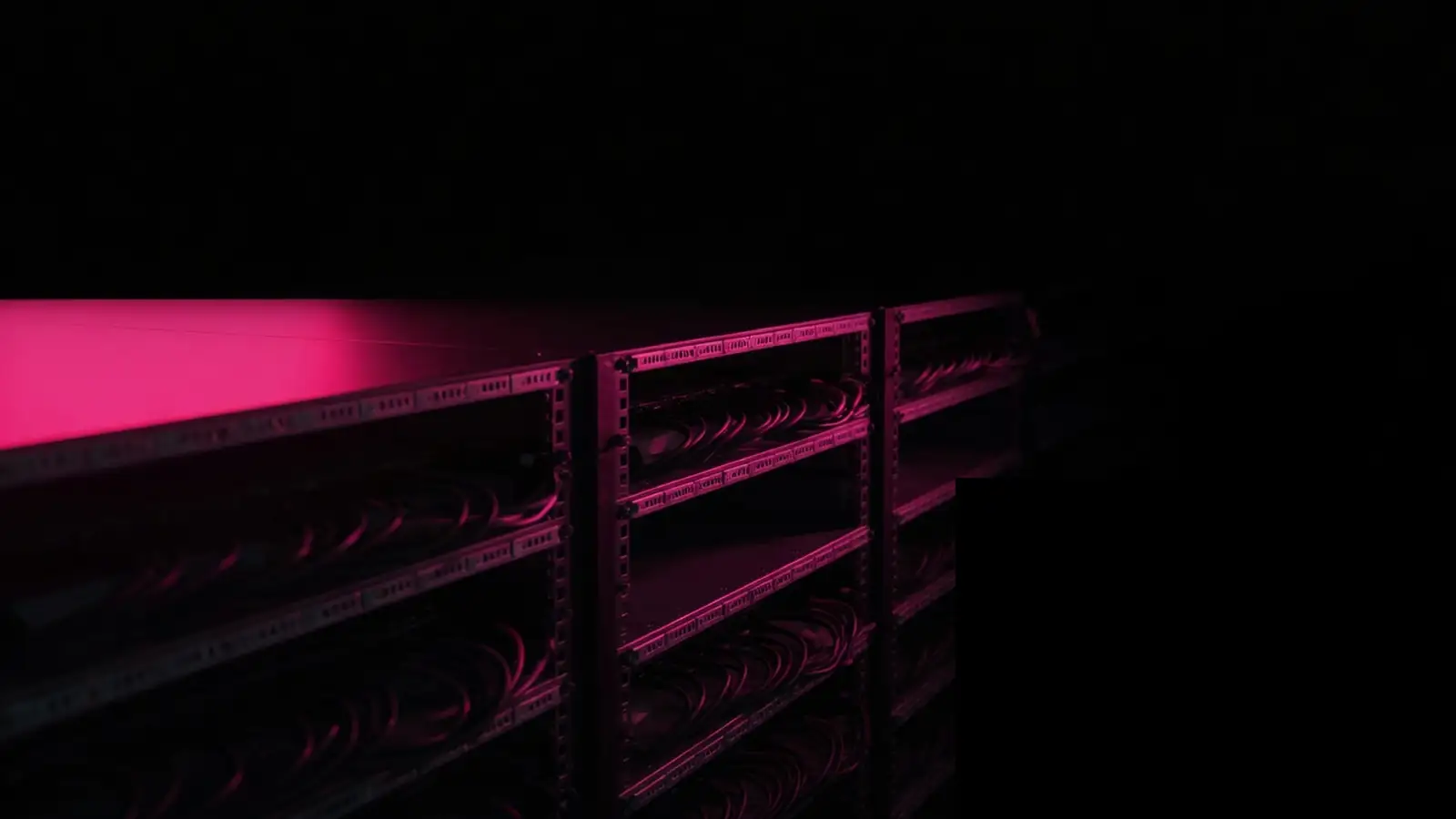 Dark rack aisle with magenta edge light, what self-hosting actually costs as total cost of ownership